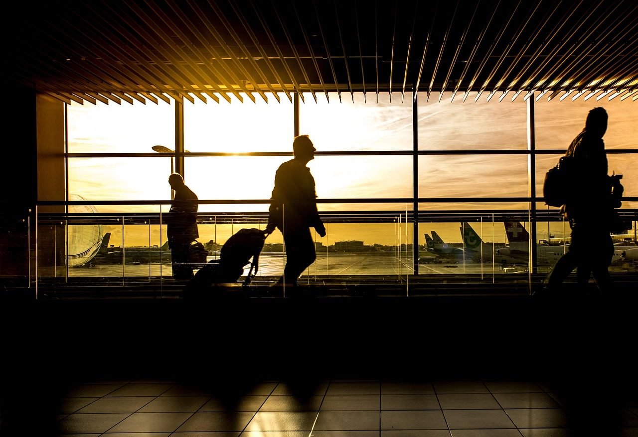 Traveller with luggage in an airport terminal during a busy school holiday period