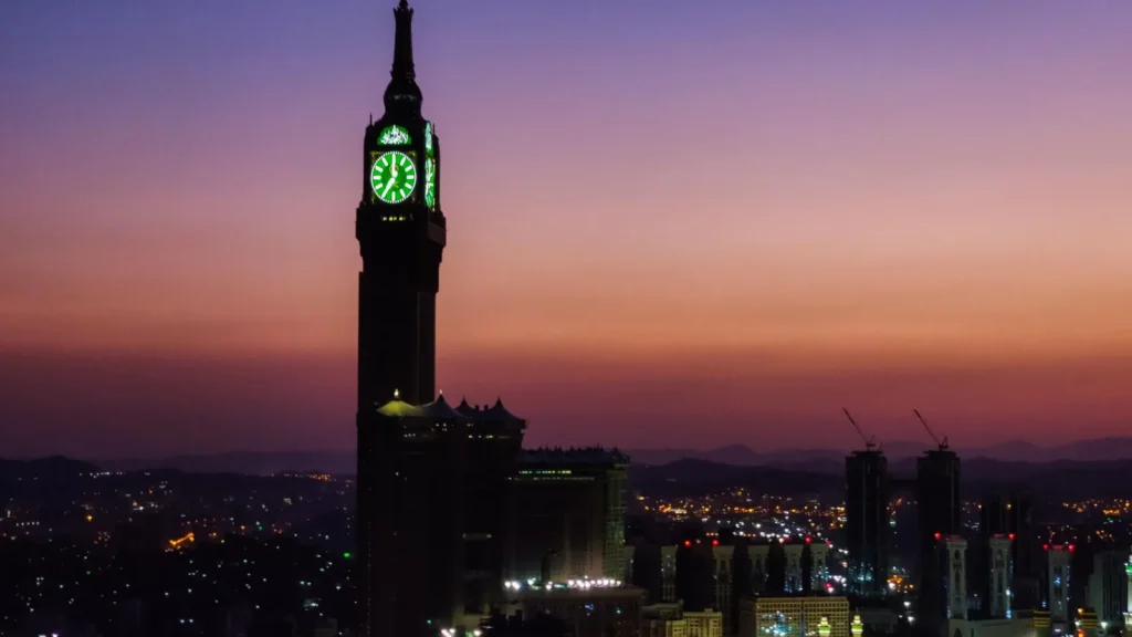 Makkah clock tower silhouetted against a dusk sky