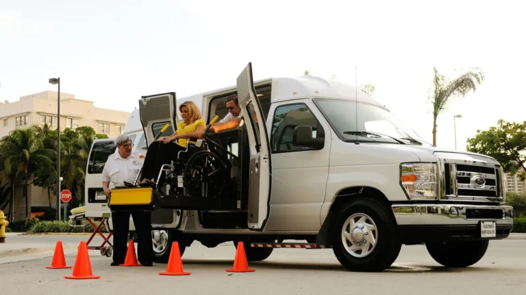Wheelchair lift lowering a passenger into an accessible van