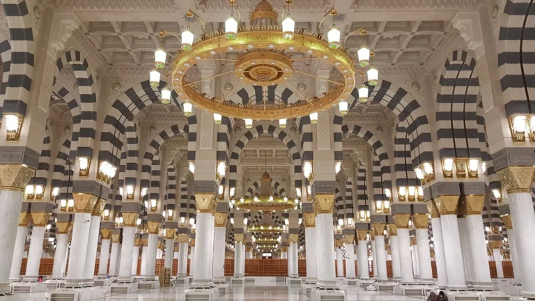 Interior of the Prophet's Mosque in Madinah with arches and chandeliers