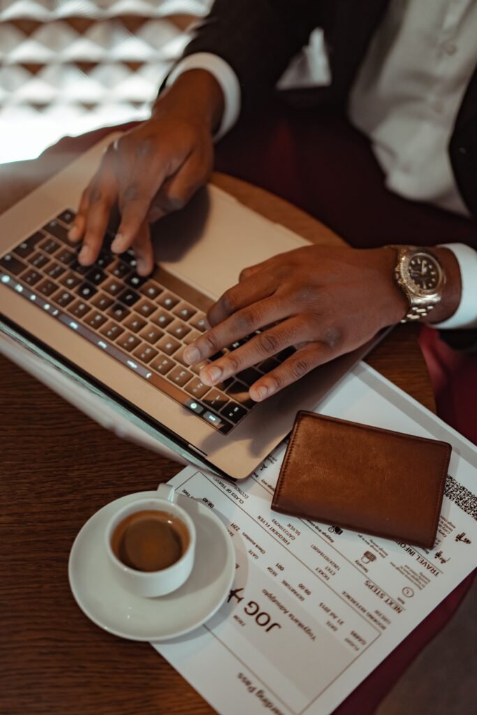 A traveller using a laptop to complete online documents before a trip