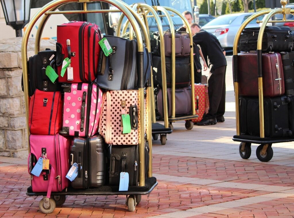 Airport porter with luggage cart assisting a traveller