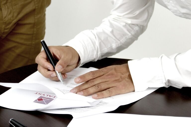 Person signing an insurance style document representing transport cover
