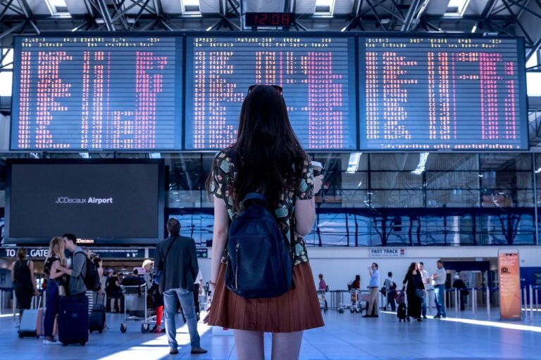 Airport terminal at night with a driver waiting to meet an arriving passenger