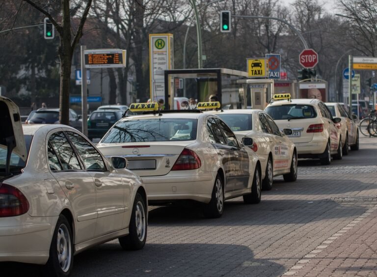 Taxi rank at an airport representing licensed transport options for pilgrims