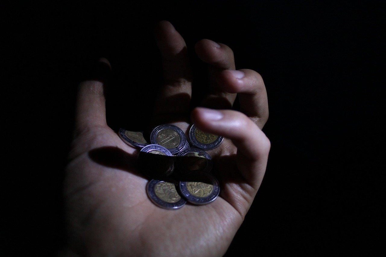 Cash in hand representing a small payment to a driver