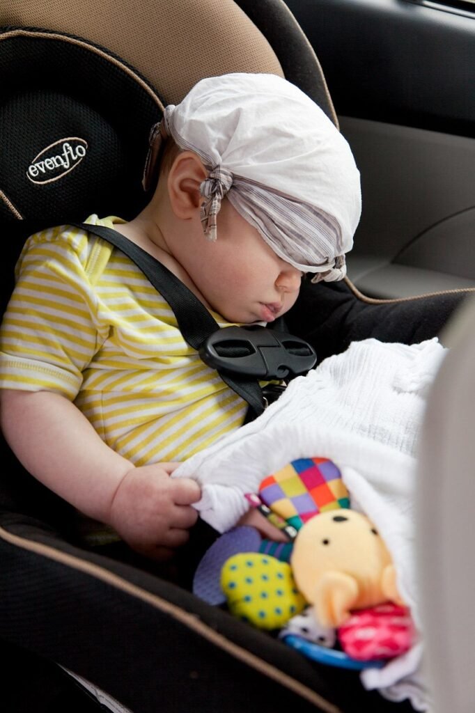 Parents fitting an infant car seat before an airport taxi transfer