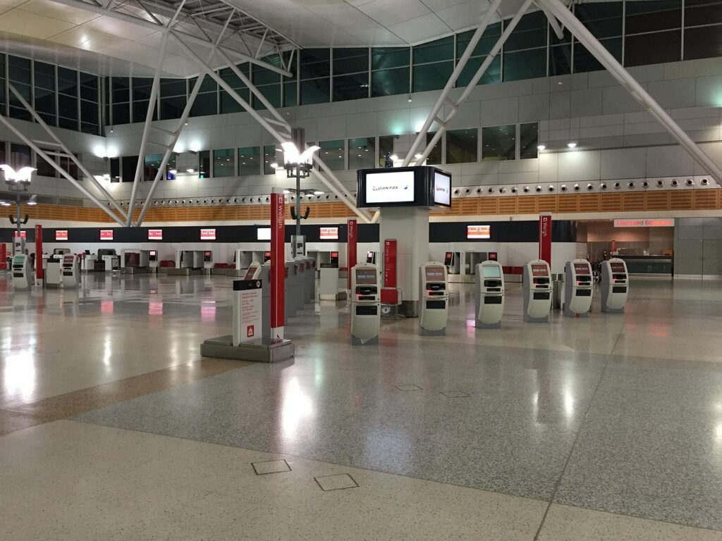 Travellers with luggage arriving at an airport terminal
