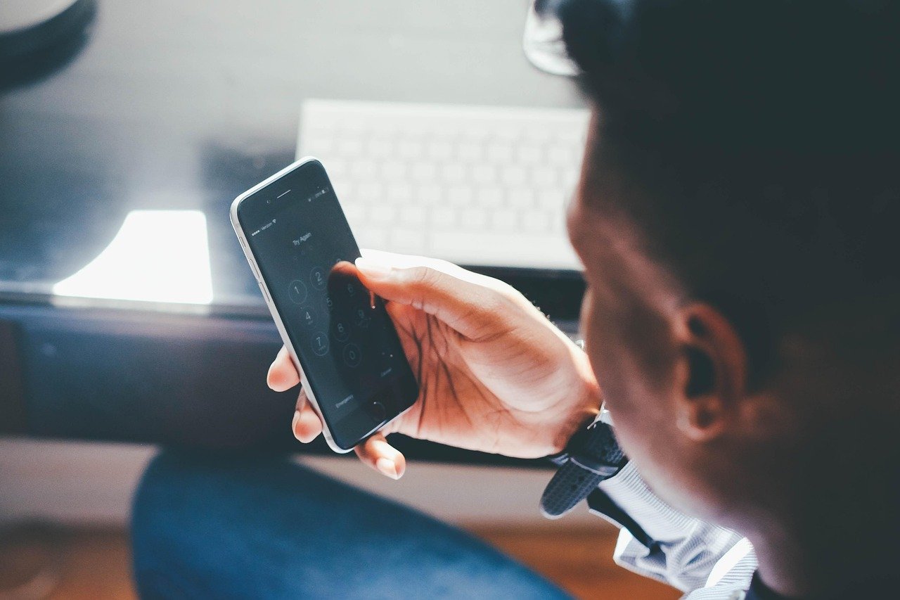 Person researching on a phone representing checking a transport provider before booking