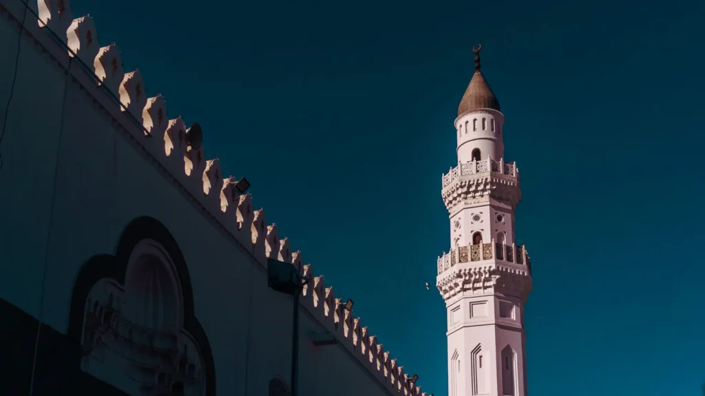 Minaret of Quba Mosque in Madinah against a deep blue sky