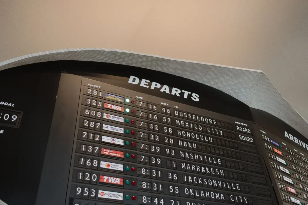 Close-up of an airport departures board listing flight times and destinations