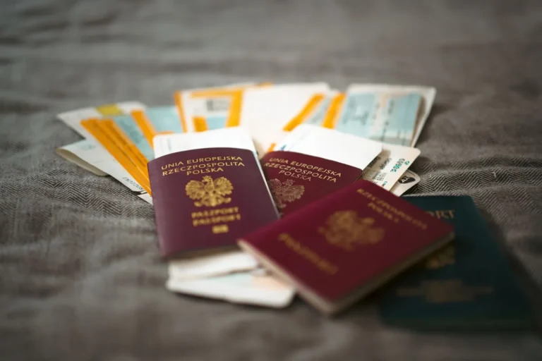 Two passports and printed travel tickets laid out before a trip
